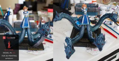 A multi-headed dragon with a girl standing on top, painted and displayed on a crafting table.