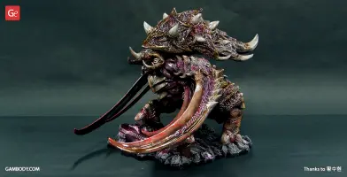 A detailed 3D printed Ultralisk from StarCraft, showcasing its massive body and curved tusks on a display base.