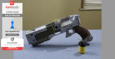 A 3D-printed model of a laser pistol from Fallout 4, displayed on a blue surface.