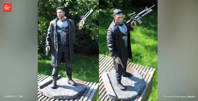 A 3D-printed figure of a man in a long coat holding a rifle and a pistol, standing on a textured base.