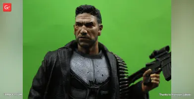 A detailed 3D print model of The Punisher, in tactical gear, holding a rifle against a green background.