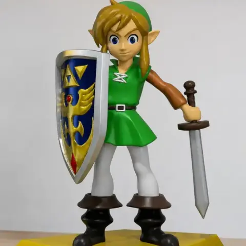 Elf-like character with shield and sword, wearing a green outfit, standing on a yellow base.
