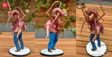 A grotesque creature with human features and spider-like limbs emerging from a body.