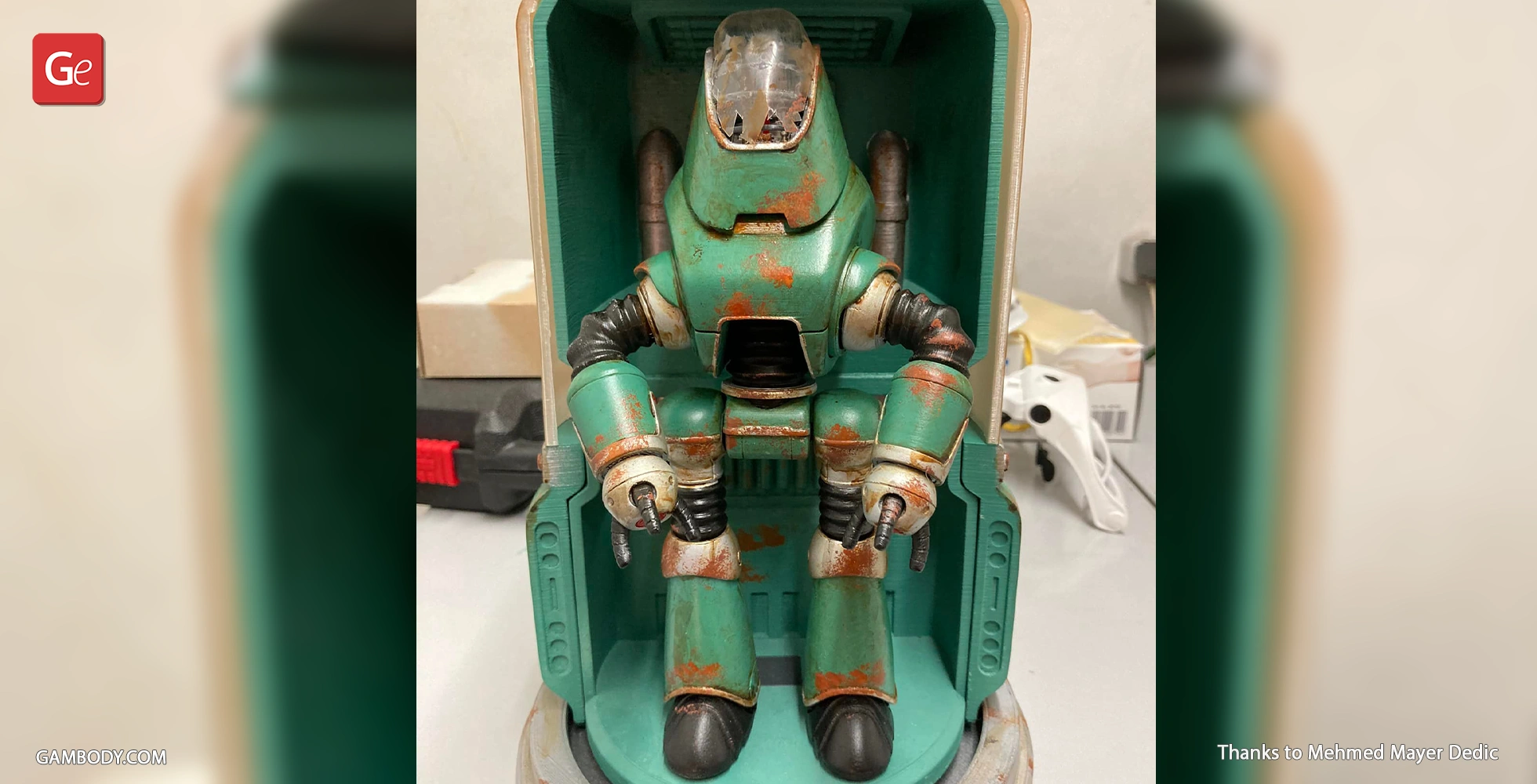 A weathered, teal Protectron robot model from Fallout, with rust details, in a display case.