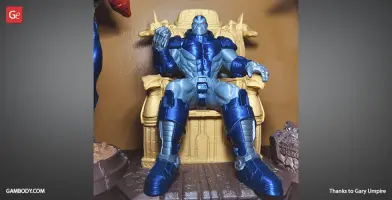 A detailed 3D model of a muscular figure in blue armor seated on a throne, ready for 3D printing.