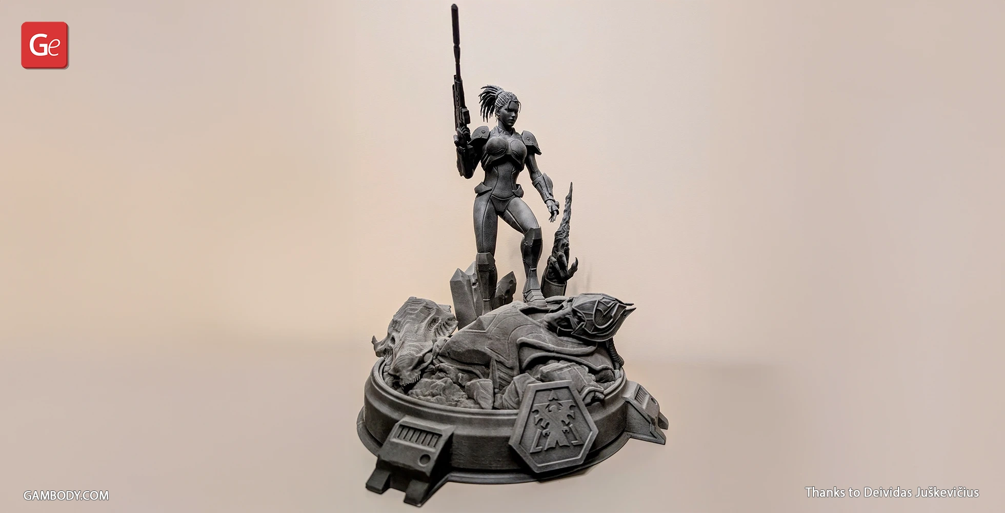 A detailed 3D model of a futuristic armored figure holding a rifle, standing on a sci-fi themed base.