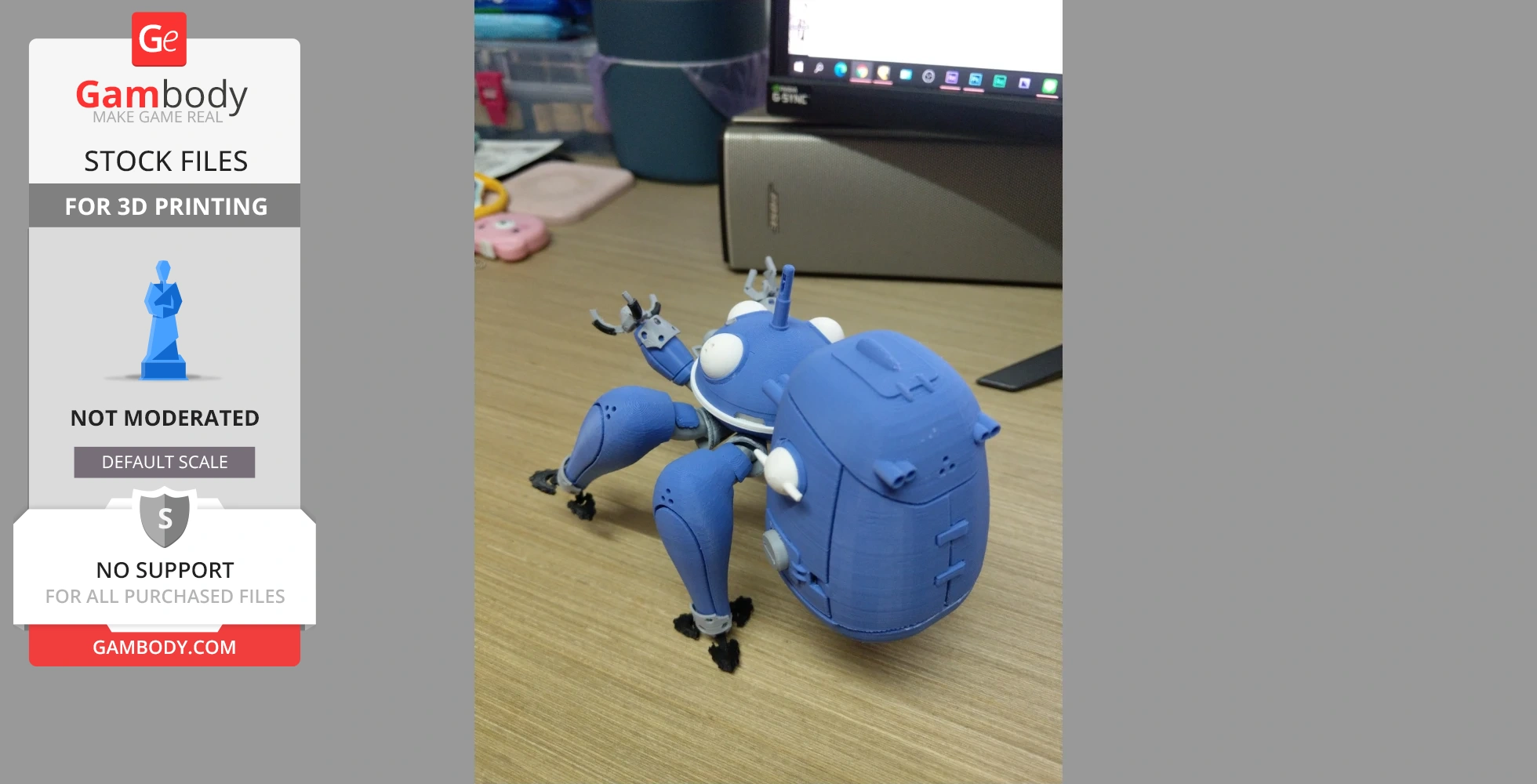 A blue 3D-printed Tachikoma robot model sitting on a wooden desk.
