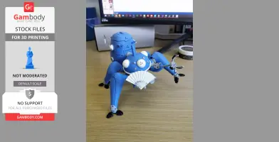 A blue 3D-printed Tachikoma robot model with articulated limbs on a wooden desk.