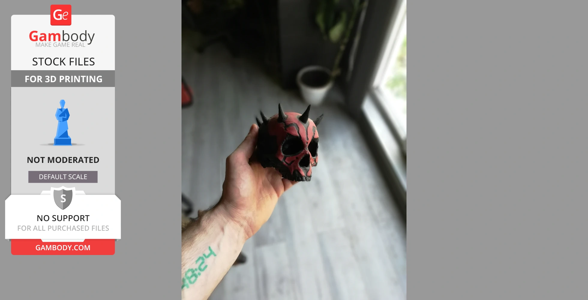 A hand holding a 3D printed Darth Maul-inspired skull with red and black detailing and spikes.