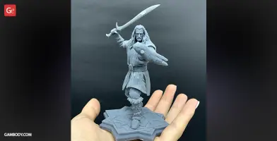 3D-printed figure of a warrior with a sword and shield, standing on a detailed base.