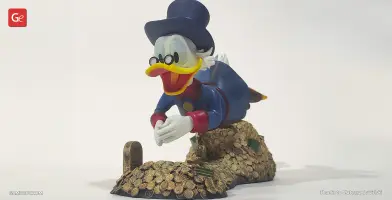 A 3D model of a cartoon duck diving into a pile of gold coins, wearing a blue suit and top hat.