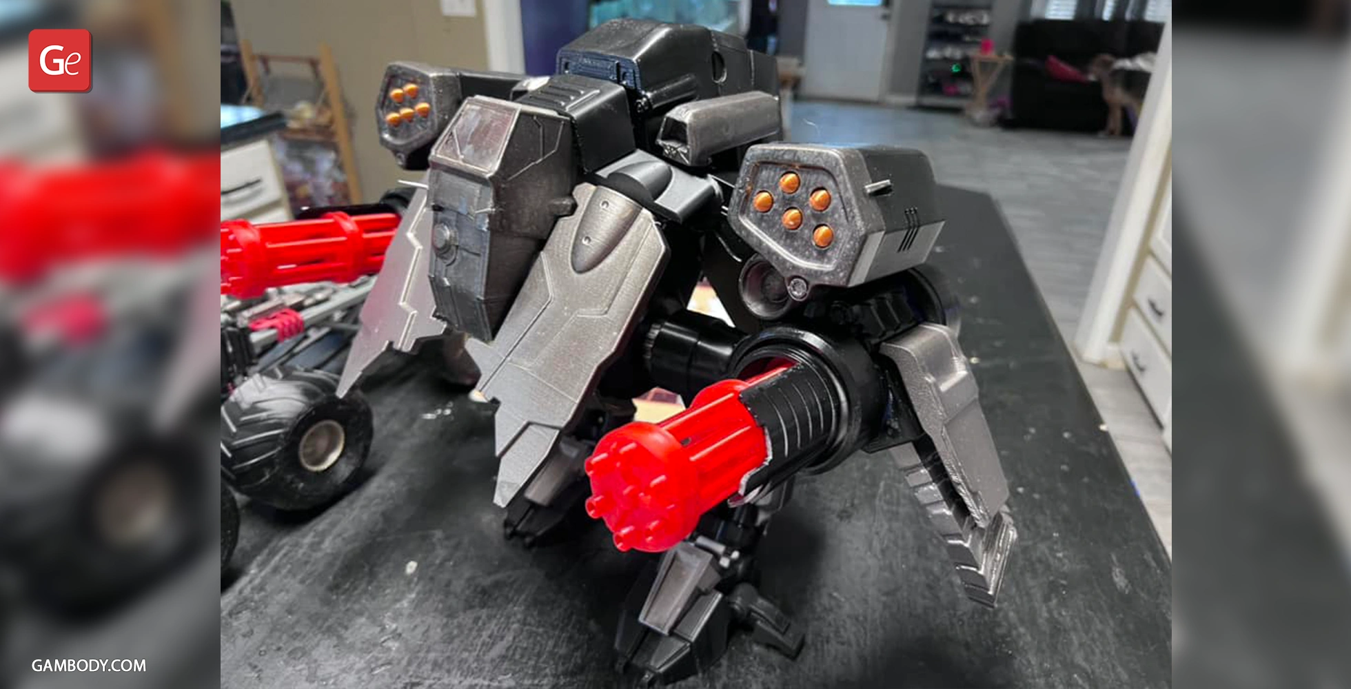 A detailed 3D model of a robotic mech with red guns and armored plating from StarCraft, captured on a table.