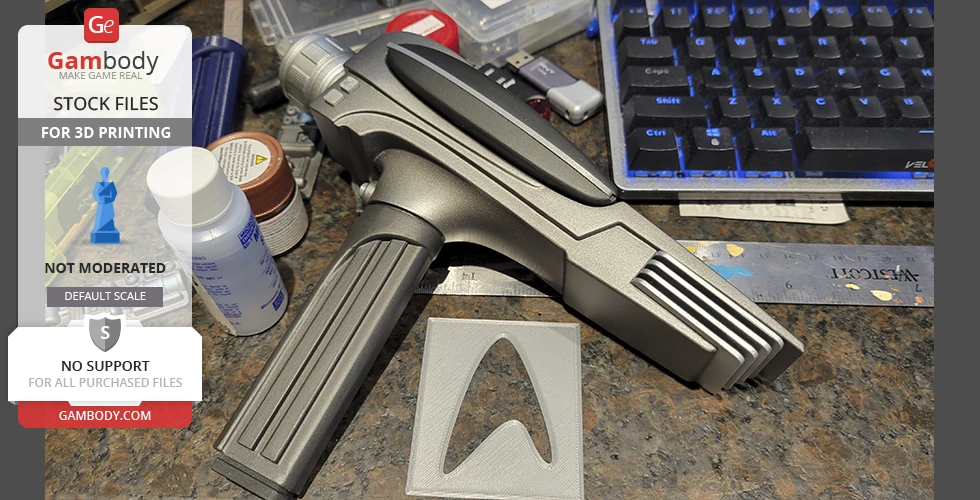 A 3D-printed Star Trek Phaser MK2 model, shown on a desk near a keyboard and various tools.