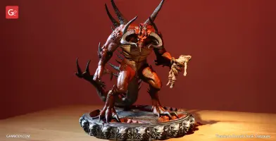 Demon-like figure with horns and spikes, holding a small figure, stands on a detailed circular base.