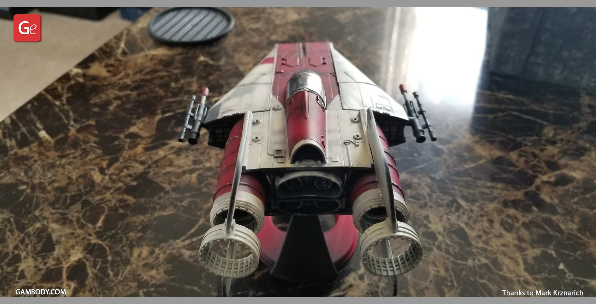 3D printed model of the RZ-1 A-Wing starfighter, featuring detailed engines and cockpit on a marbled surface.