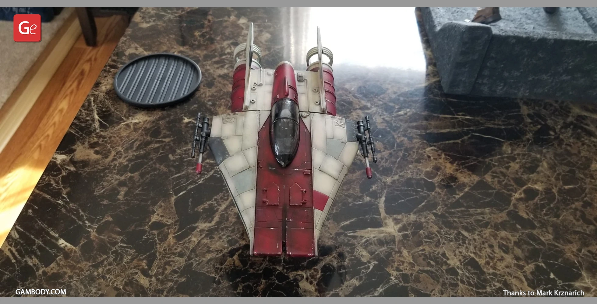 Detailed 3D-printed model of an RZ-1 A-Wing starfighter on a marble tabletop.
