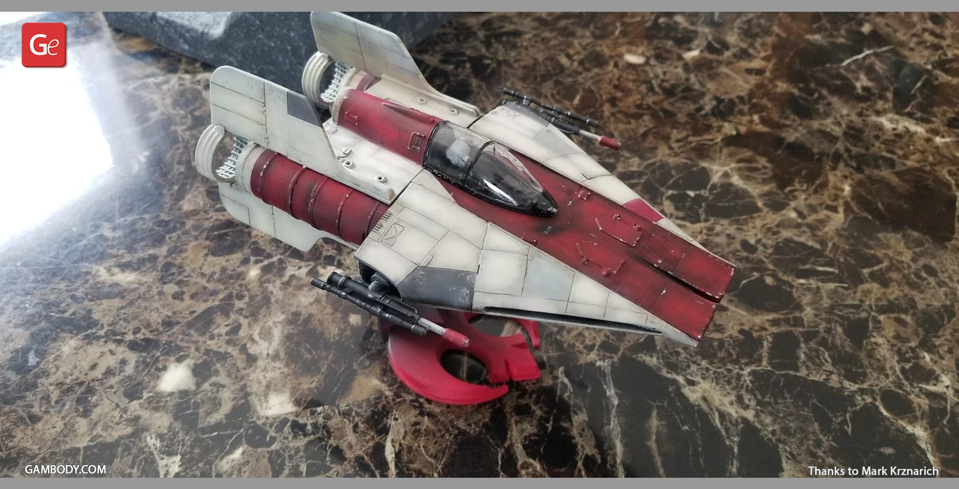 A detailed 3D-printed RZ-1 A-Wing starfighter model on a marbled surface.