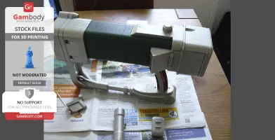 A 3D-printed Fallout laser pistol model displayed on a table with printed components.