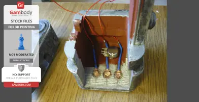 3D-printed Fallout laser pistol components with wiring and detailed textures on a wooden surface.