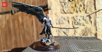 A 3D-printed figure with long hair, a black wing, and a long sword, standing on a decorative base.