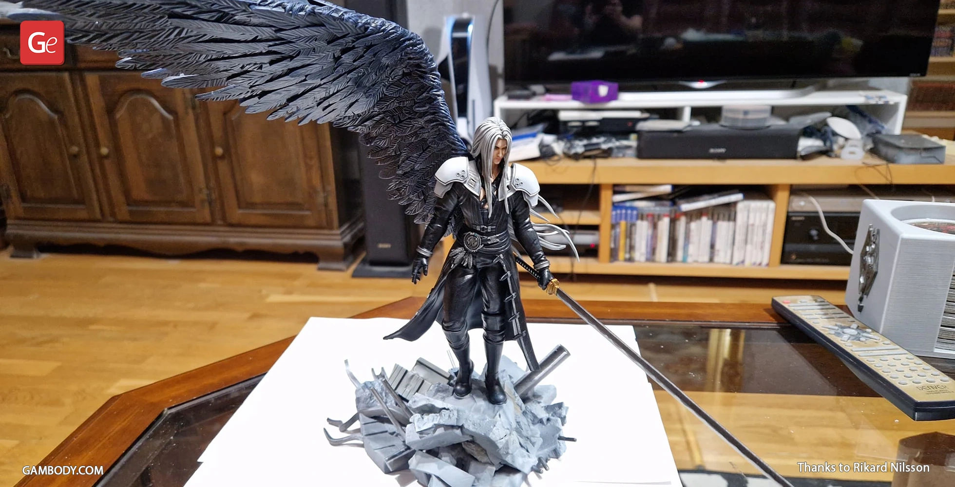 3D model of a black-clad warrior with long hair, large wing, and sword standing on rocky debris.