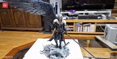 3D model of a black-clad warrior with long hair, large wing, and sword standing on rocky debris.