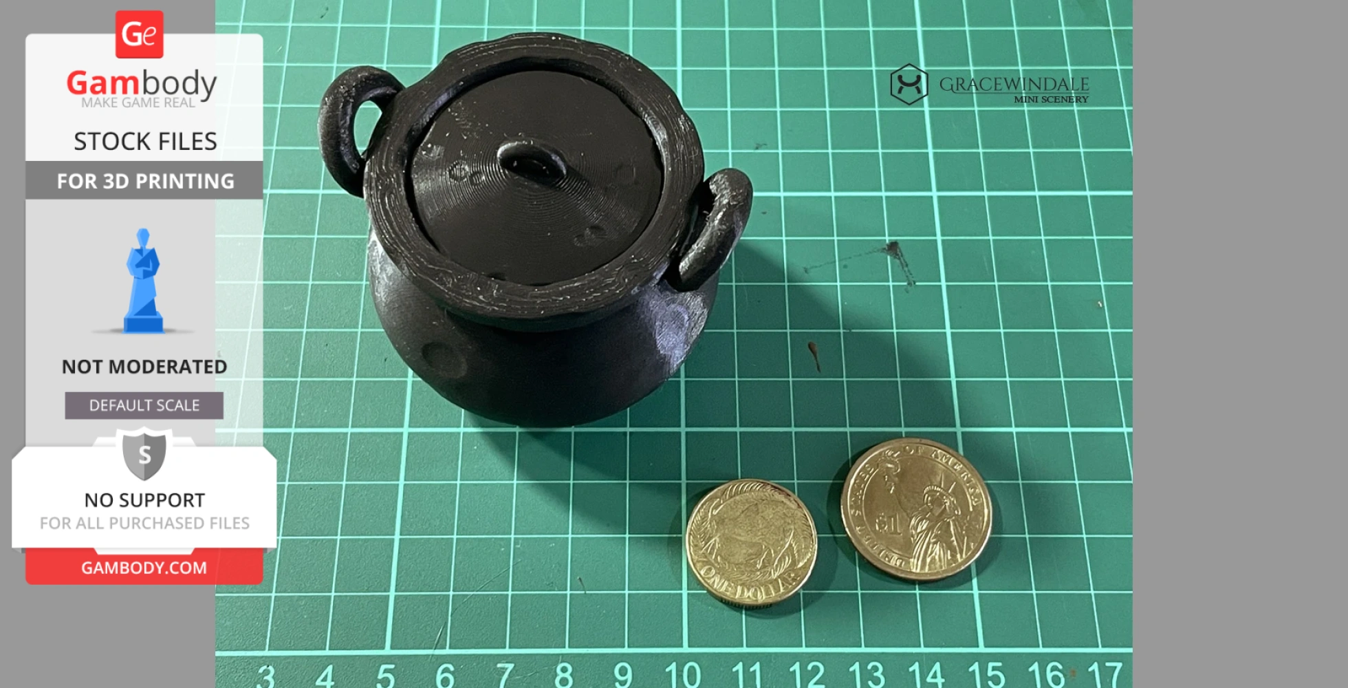 Black 3D-printed cauldron with lid and handles, placed on a grid mat next to two coins for scale.
