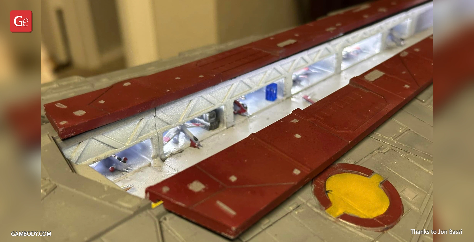 Close-up of a detailed Venator-class Star Destroyer model with red and grey panels and intricate structures.