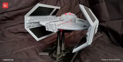 Detailed TIE Advanced 3D model on stand, featuring angular wings and cockpit, ready for 3D printing.