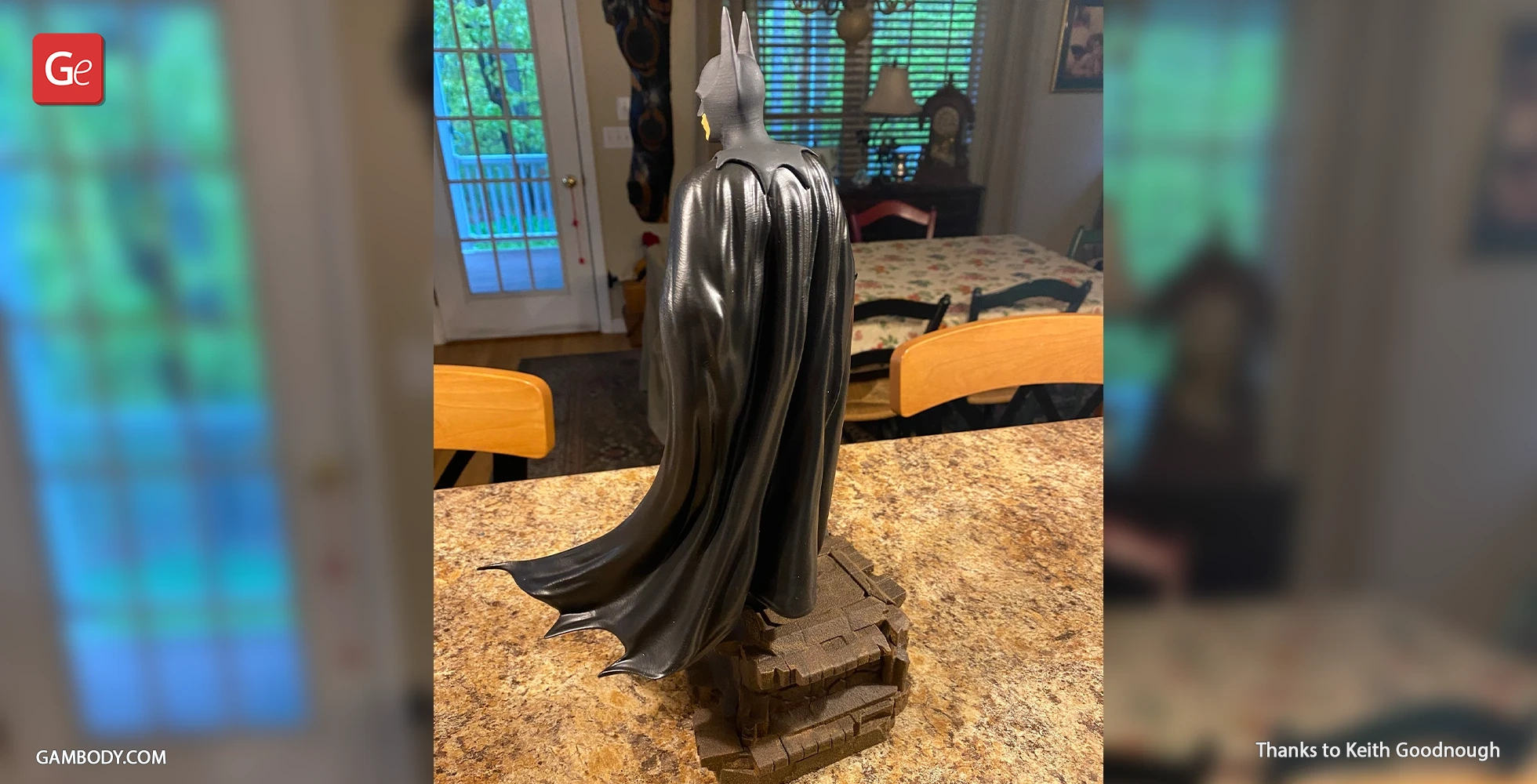 3D printed Batman 1989 figurine with cape, standing on a rocky base.