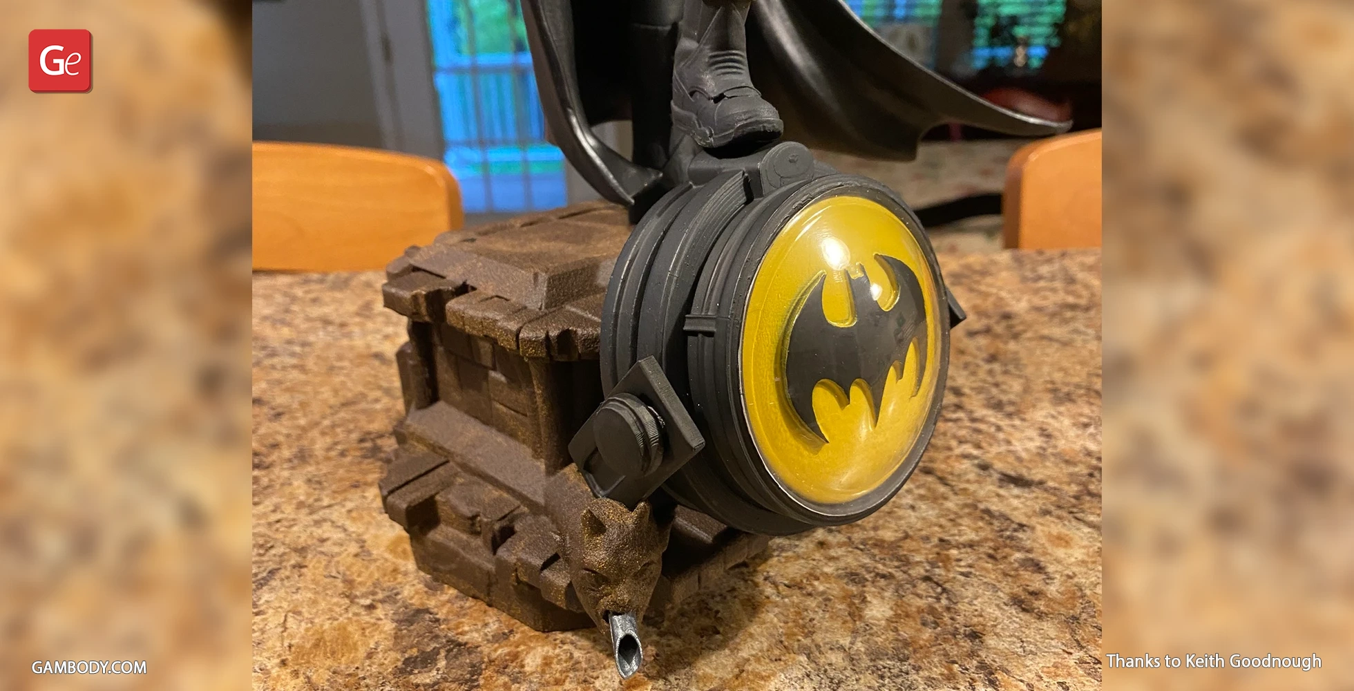 A 3D-printed Batman spotlight on a detailed stone base, featuring the iconic bat symbol.