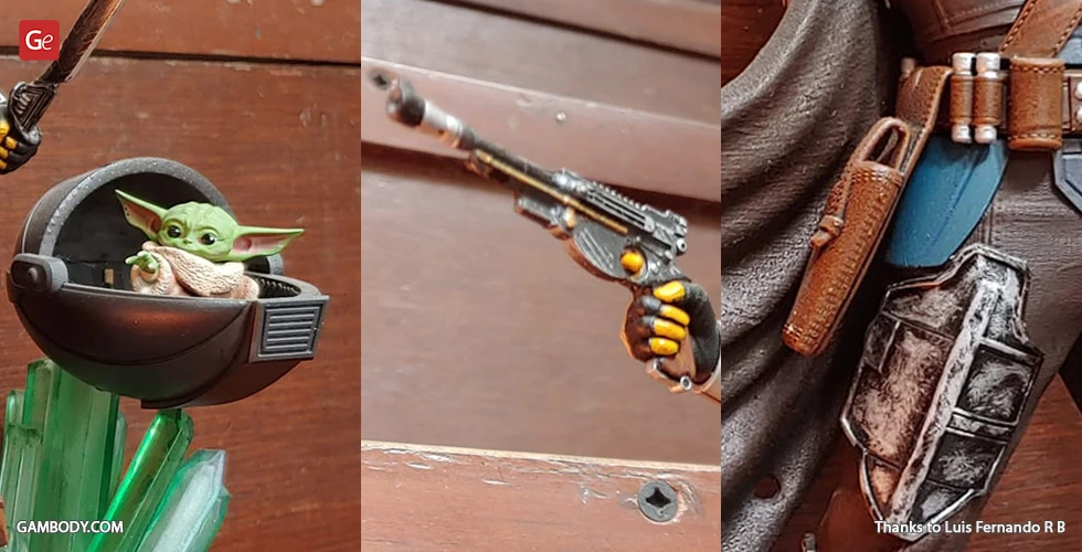 A detailed 3D printed model of Grogu in a pod and parts of a Mandalorian character with blaster and armor.