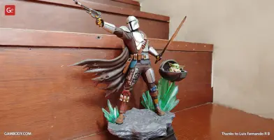 A 3D printed figure of an armored warrior holding weapons, with a small creature in a hovering pod nearby.