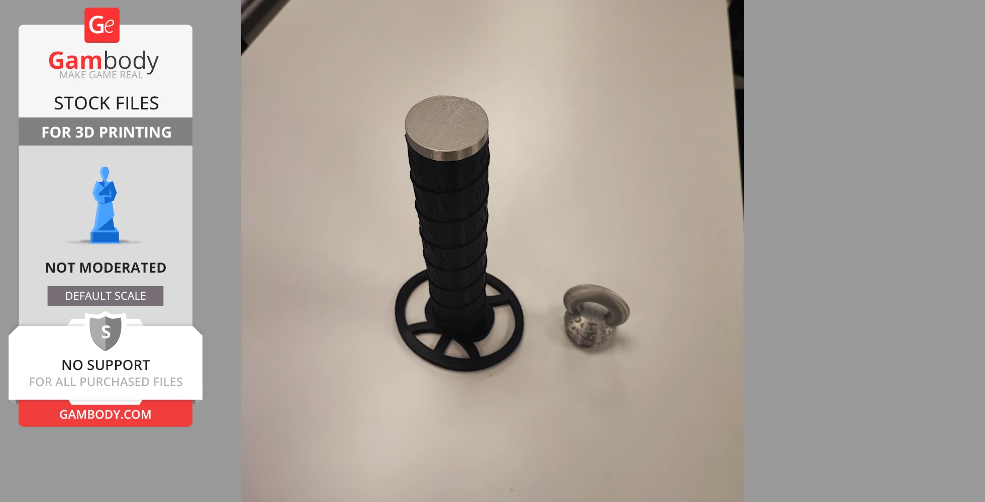 A 3D-printed, black segmented sword handle and a small round pommel, viewed from above on a table.