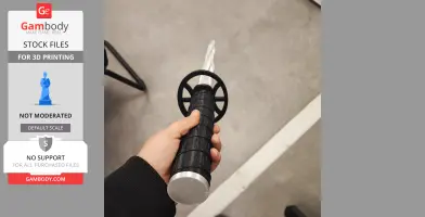 A hand holding a black and silver 3D-printed sword with a circular guard.