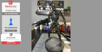 A detailed 3D-printed T-800 endoskeleton model holding a weapon, displayed on a circular base.