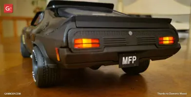 Rear view of a black Ford Falcon XB model with MFP license plate and lit taillights.