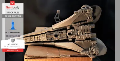 A detailed 3D-printed futuristic spacecraft model on a box, viewed from below.