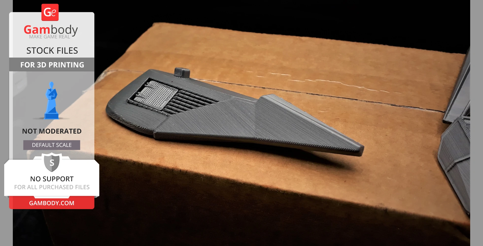 A 3D-printed part of a futuristic vehicle design, with angular features and detailed textures, on a cardboard box.