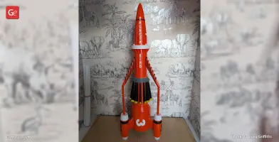 Red and white rocket model labeled 'Thunderbird 3,' displayed against a safari-themed wallpaper.