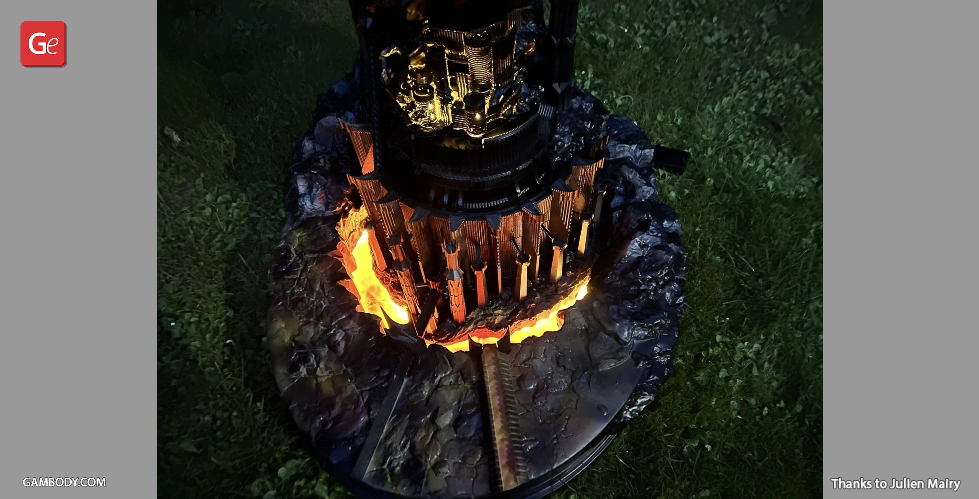 Detailed 3D model of Barad-dûr with glowing lava effect at its base, set on a grass surface.