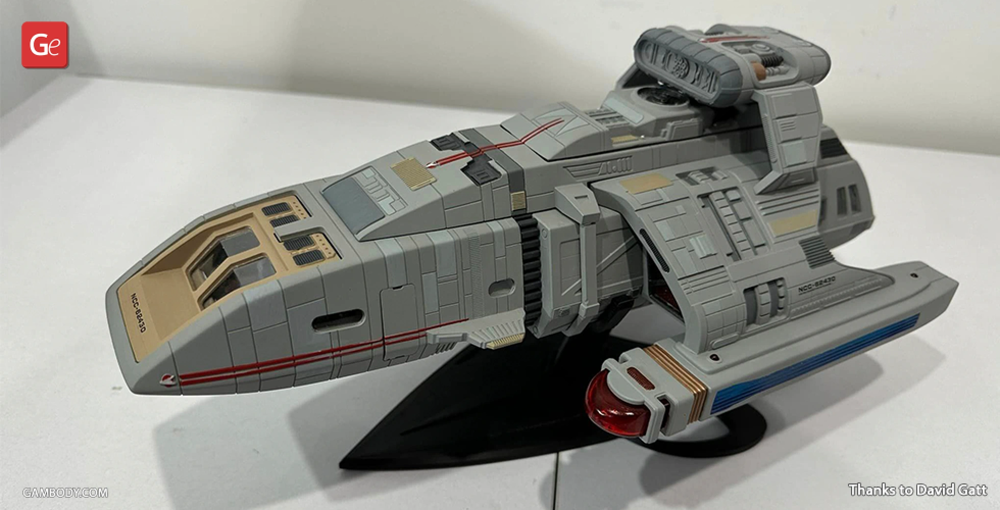 A detailed 3D model of a Danube-Class Runabout spaceship on a display stand.