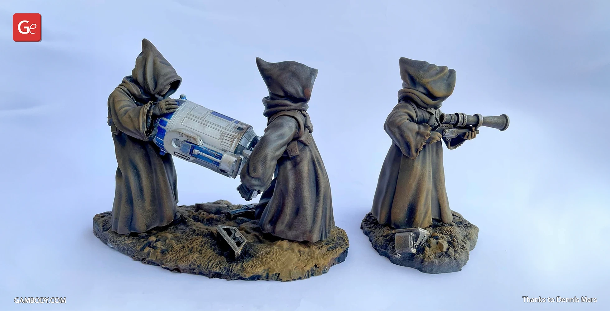 Three hooded figures examining equipment on sandy diorama bases.