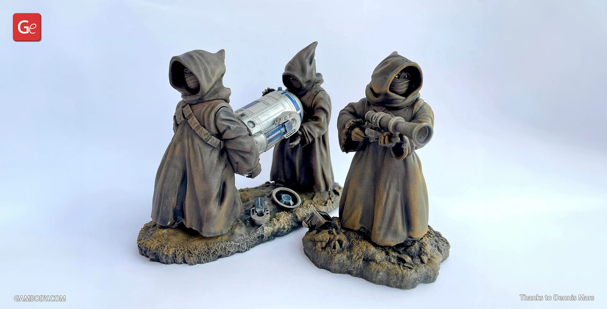 Three hooded Jawas with gadgets on rocky terrain, one holding a droid part.