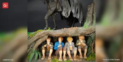 Nazgul on horseback above hobbits hiding under a tree, depicted in a detailed diorama.