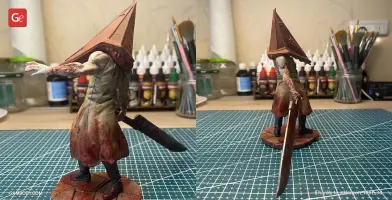 Pyramid Head figurine, wielding a large sword, stands on a base, ready for 3D printing.