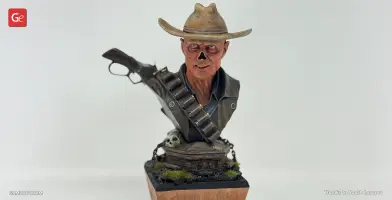 Cowboy ghoul bust with wide-brimmed hat, bandolier, and a rifle slung over shoulder, atop a decorated base.