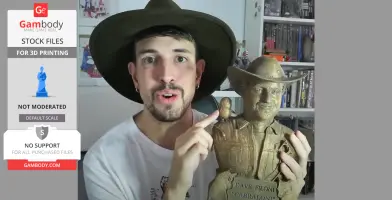 Person holding a 3D-printed bust with a hat, featuring details like a bird on the shoulder.