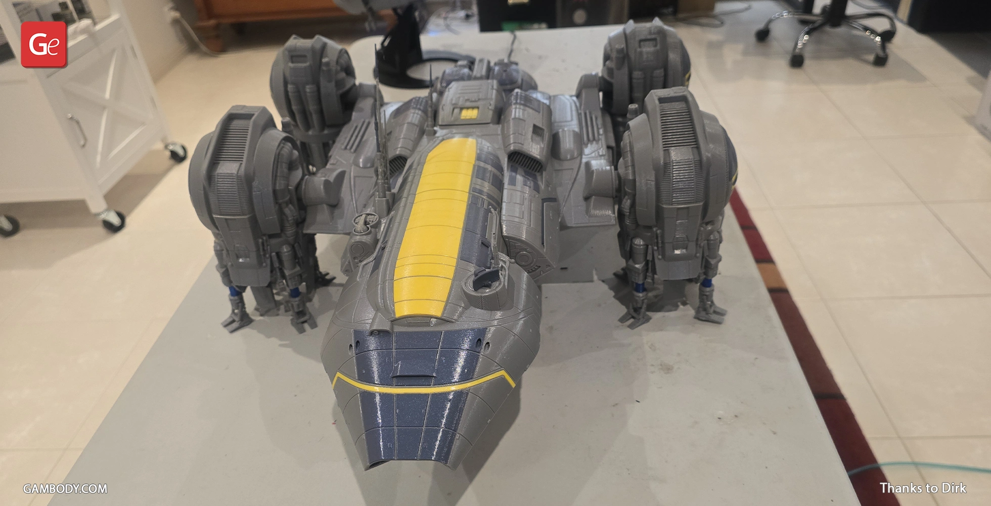 Gray and yellow 3D-printed model of USCSS Prometheus spaceship on a table.