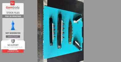 Several 3D printed sections of the Titanic ship model laid out on a blue surface with a ruler for scale.